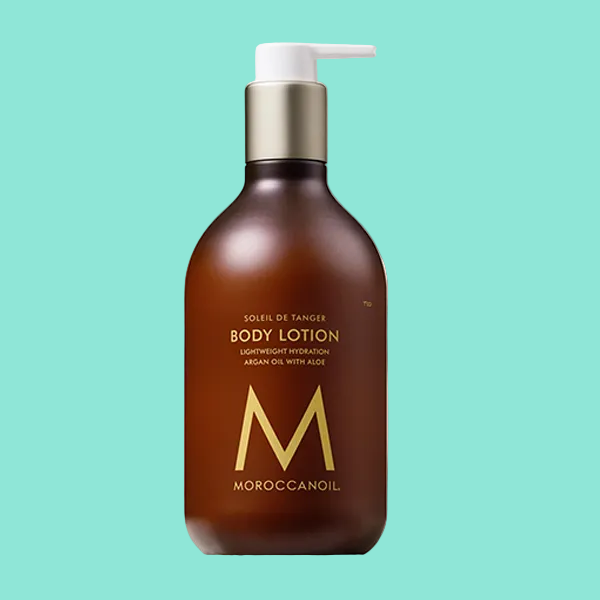 Brown body lotion bottle with pump and Moroccanoil logo on a white background