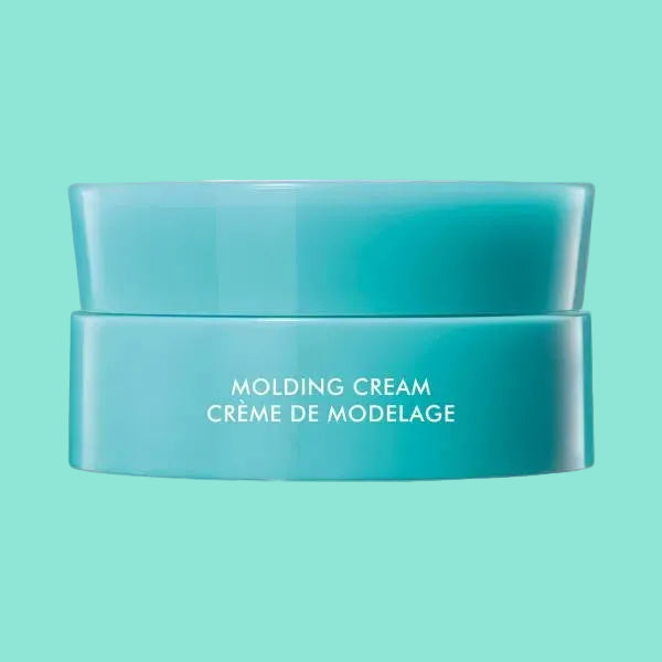 Blue jar of molding cream with white text on a white background