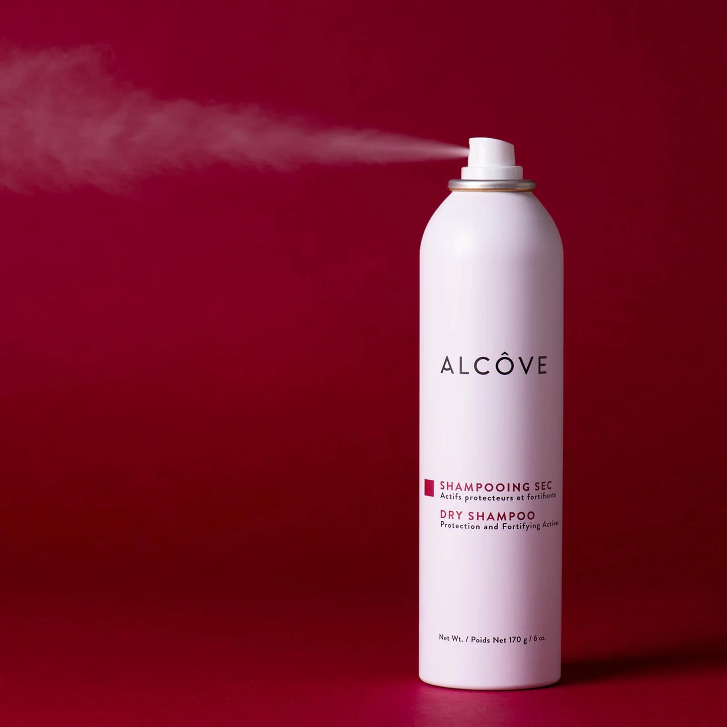 Alcove dry shampoo can on a red background