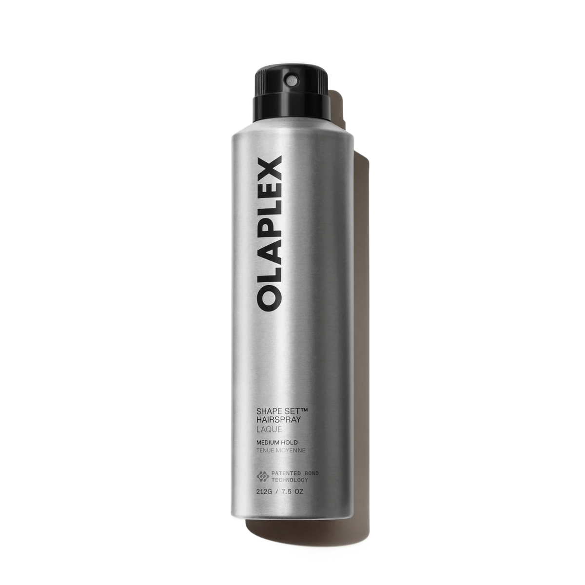 A silver aerosol can of Olaplex Shape Set Hair Spray with a black spray nozzle, photographed on a clean white background with a soft shadow.