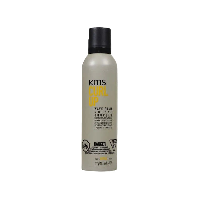 KMS Curl Up Wave Foam Mousse in a matte gray bottle with a black cap, featuring yellow and black text on the label.