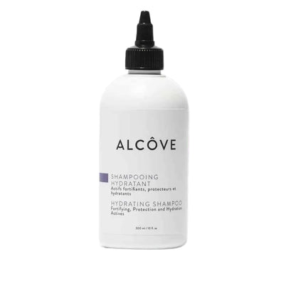 A bottle of Alcôve hydrating shampoo with a white label and black cap.