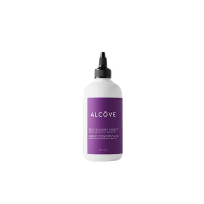 A bottle of Alcôve violet conditioner with a white label and purple text, emphasizing its vegan and sulfate-free properties.