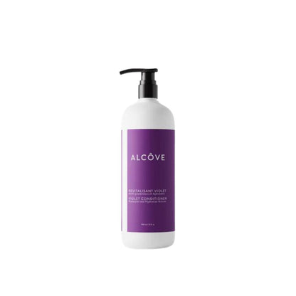 A bottle of Alcôve violet conditioner with a white label and purple text, emphasizing its vegan and sulfate-free properties.