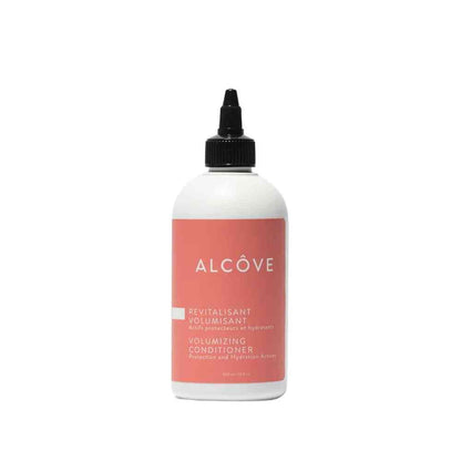 A bottle of Alcôve volumizing conditioner with a white label and pink text.