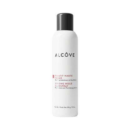 A bottle of Alcôve Strong Hold Hairspray with white and red labeling, against a white background.