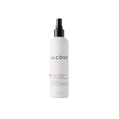 A white spray bottle with black and pink label text, branded as Alcove.