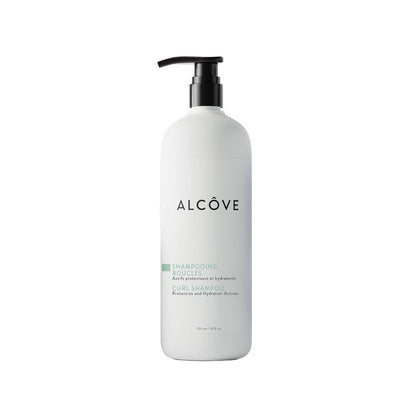 White bottle with black pump labeled 'Alcove' on a white background