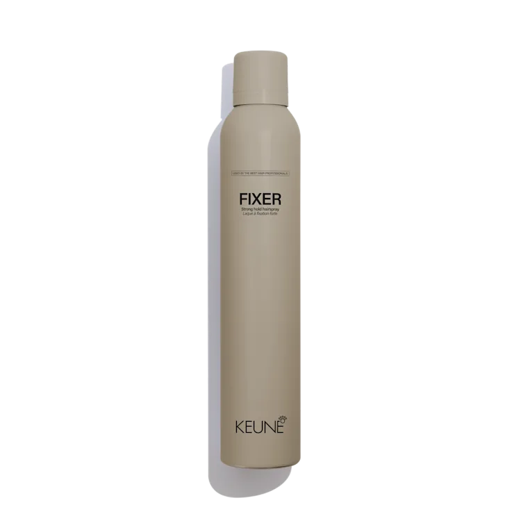 Beige hair product bottle labeled 'Fixer' by Keune on a white background