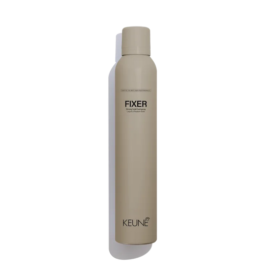 Beige hair product bottle labeled 'Fixer' by Keune on a white background