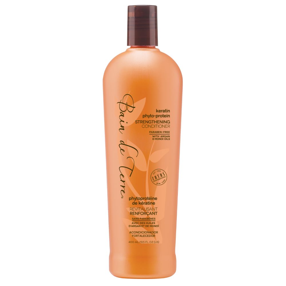 Orange shampoo bottle with brown cap on a white background