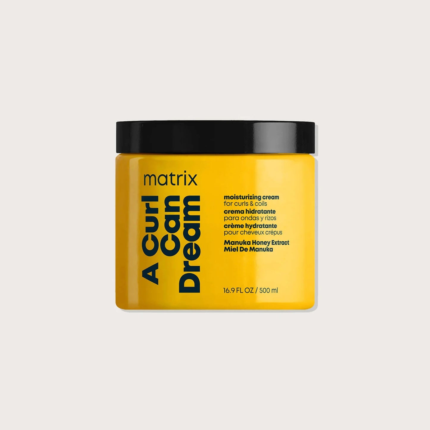 Yellow jar of Matrix Total Results A Curl Can Dream product on a beige background