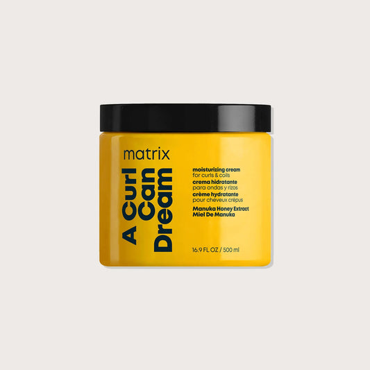 Yellow jar of Matrix Total Results A Curl Can Dream product on a beige background