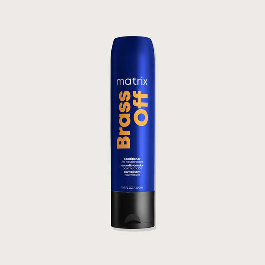 Blue bottle of Matrix Brass Off conditioner on a light gray background