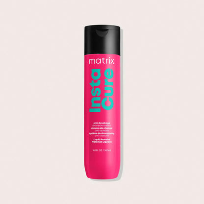 Pink bottle of Matrix Insta Cure on a beige background