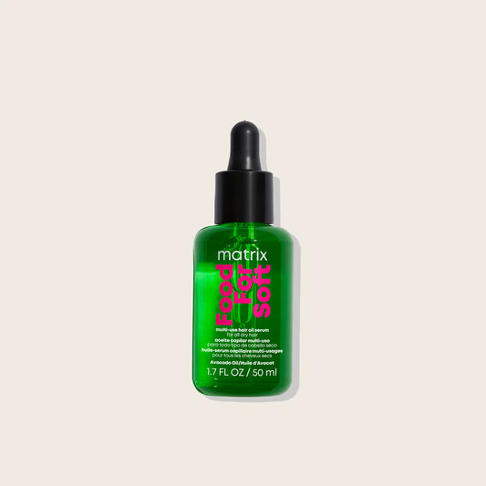 Green bottle of Matrix food for soft hair oil serum on a beige background