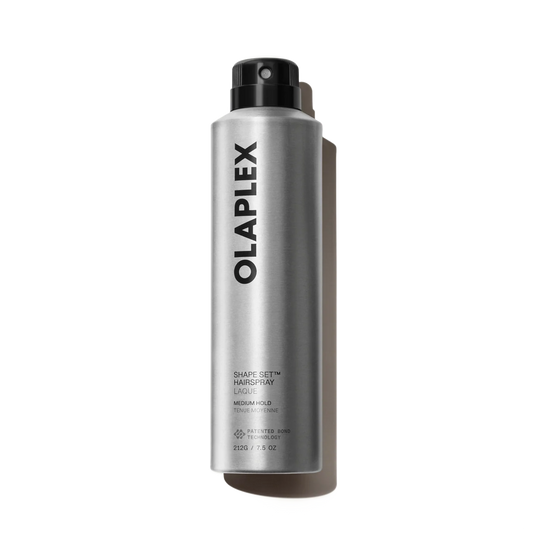 A silver aerosol can of Olaplex Shape Set Hair Spray with a black spray nozzle, photographed on a clean white background with a soft shadow.