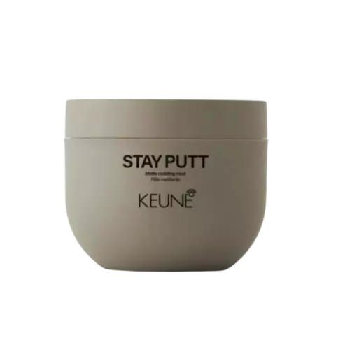 A round beige cosmetic jar labeled 'STAY PUTT' and 'KEUNE' on a plain white background.