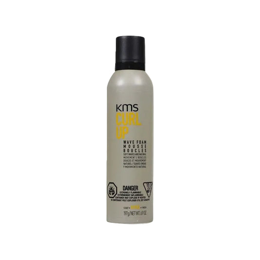 KMS Curl Up Wave Foam Mousse in a matte gray bottle with a black cap, featuring yellow and black text on the label.